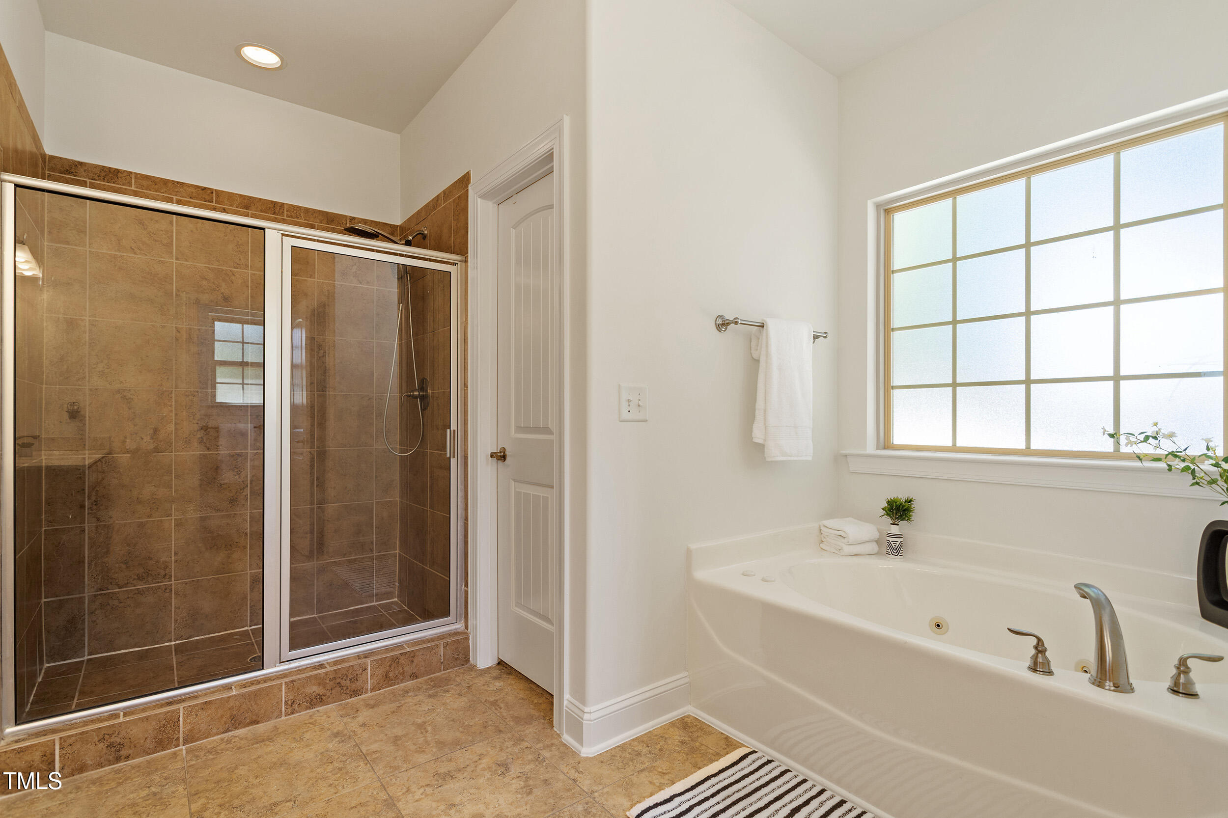 46 Spring Haven Lane Willow Spring, NC 27592 - Photo 29 of 45 a bathroom with a bathtub and a shower