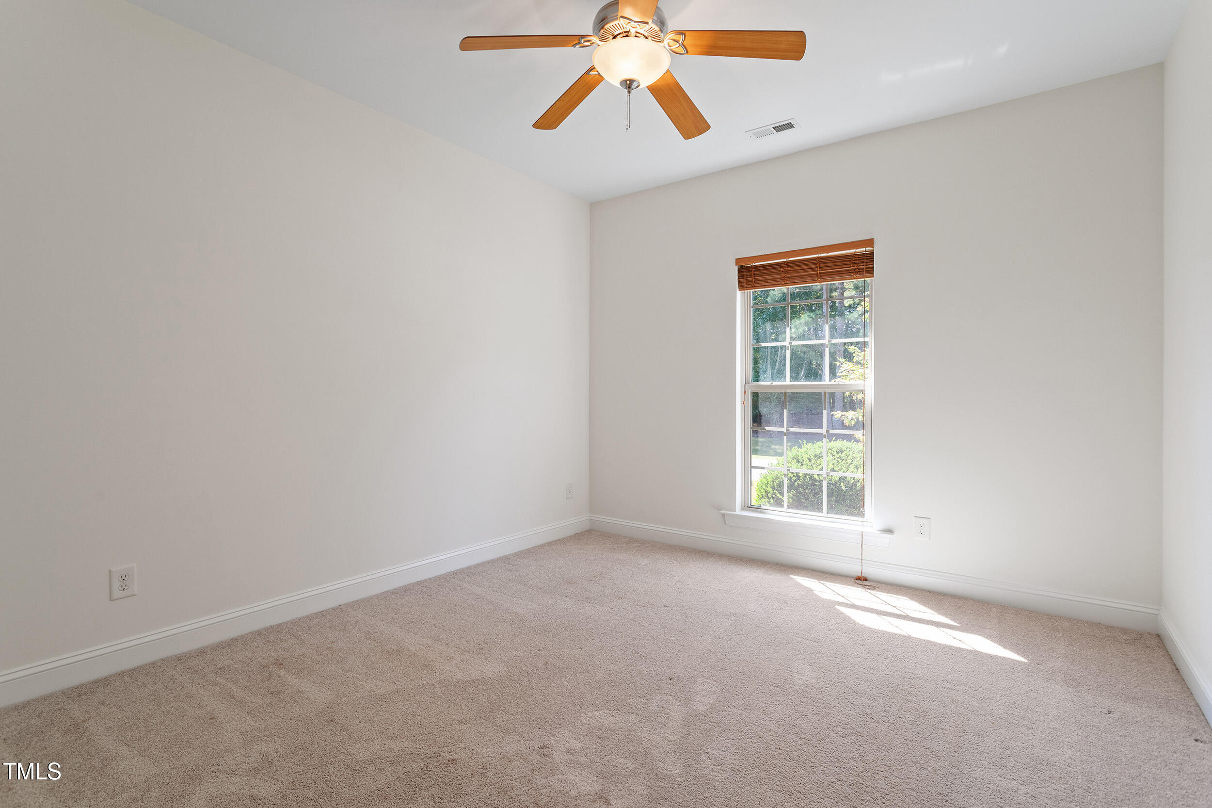 46 Spring Haven Lane Willow Spring, NC 27592 - Photo 31 of 45 an empty room with a window and a fan