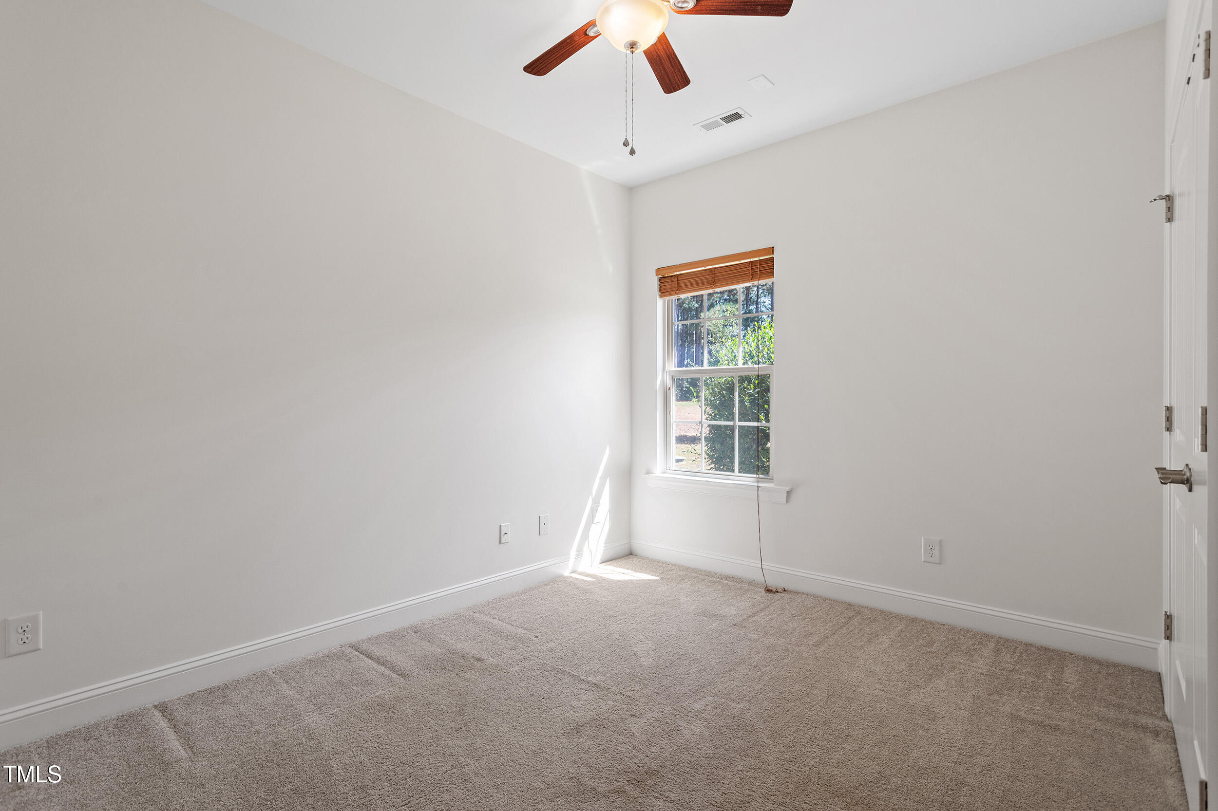 46 Spring Haven Lane Willow Spring, NC 27592 - Photo 32 of 45 an empty room with a window and a fan