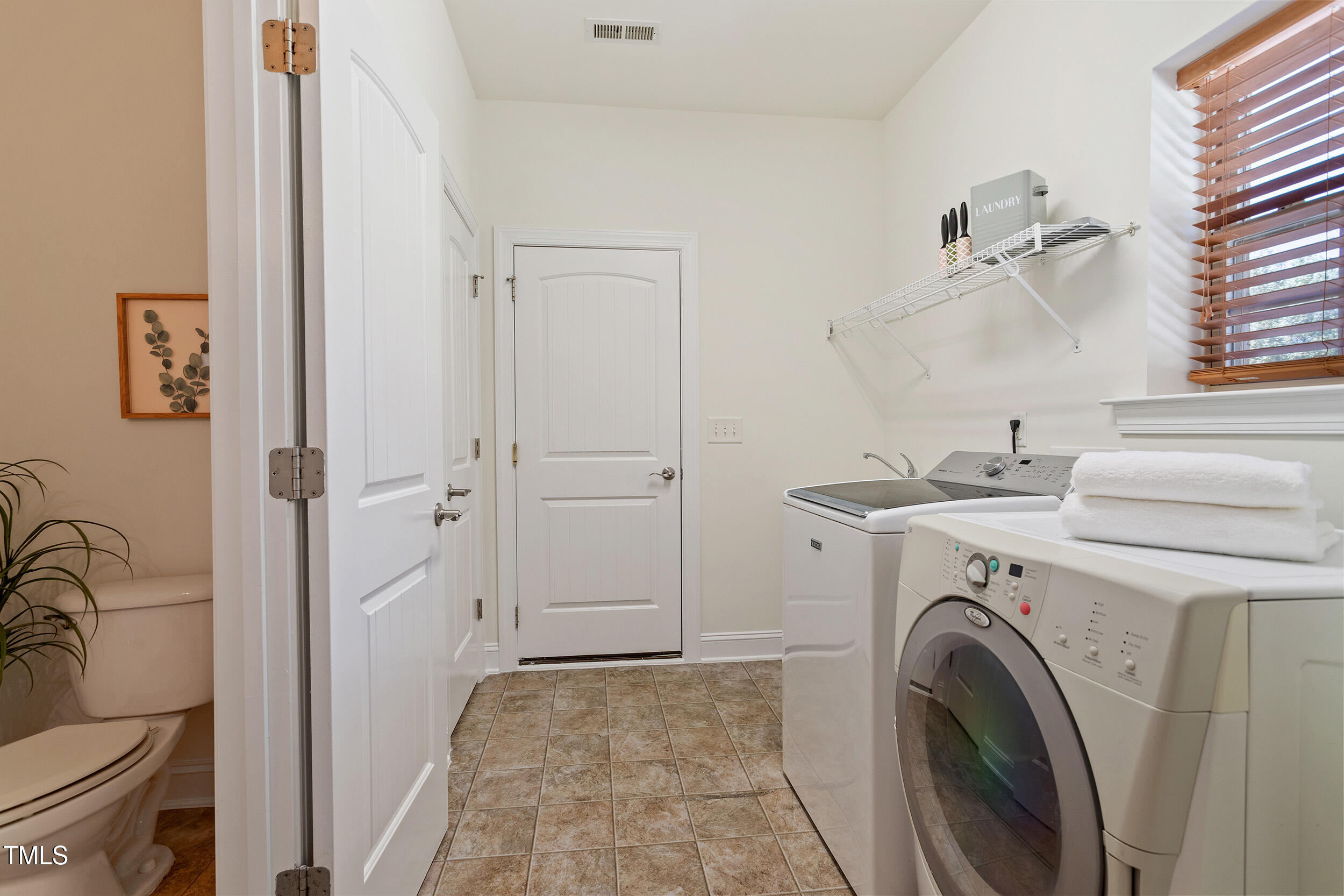 46 Spring Haven Lane Willow Spring, NC 27592 - Photo 36 of 45 a view of a hallway with washer and dryer