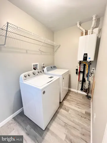 a utility room with a sink washer and dryer