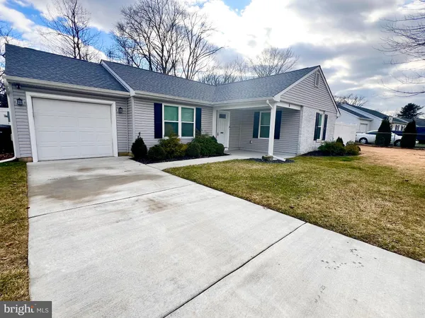 a view of a yard in front view of a house