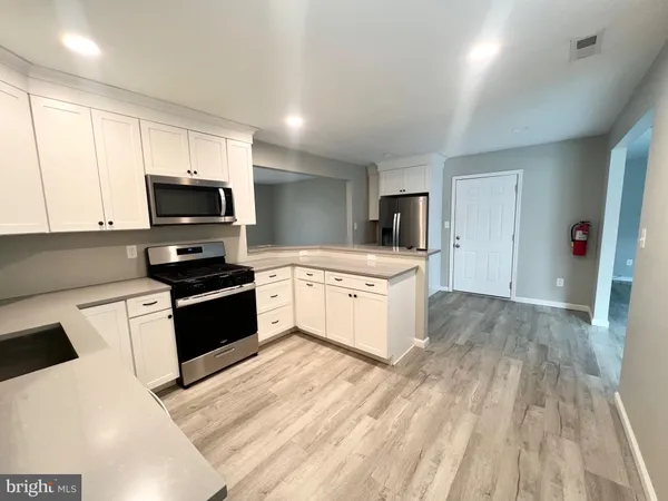 a kitchen with a stove a sink and a microwave