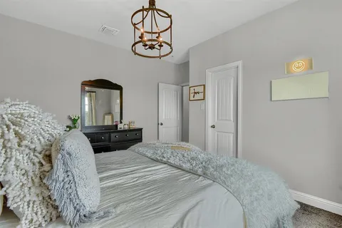 a bed sitting in a bedroom next to a window