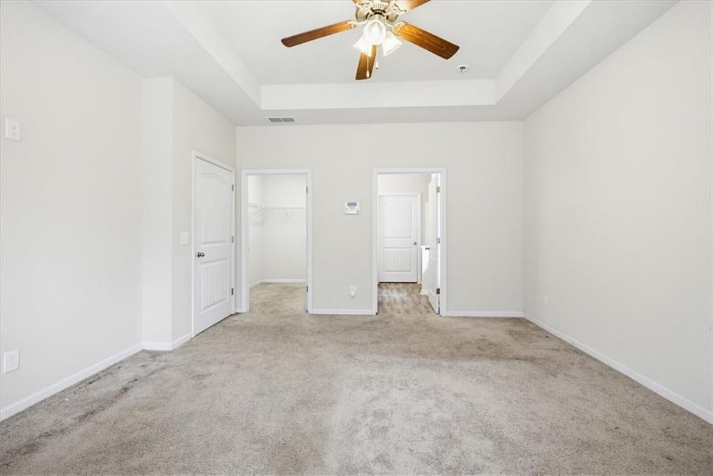 314 Boulder Run Hiram, GA 30141 - Photo 17 of 31 an empty room with a ceiling fan and carpet