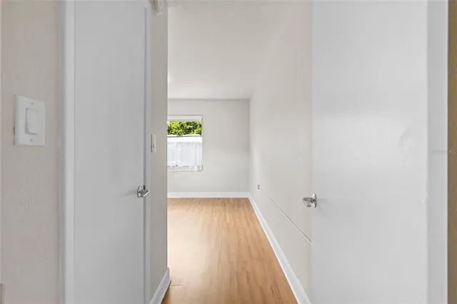 a view of a hallway with wooden floor
