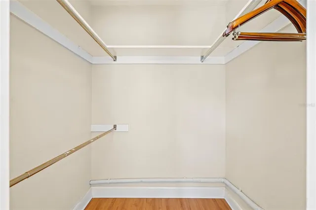 a view of walk in closet with clothes