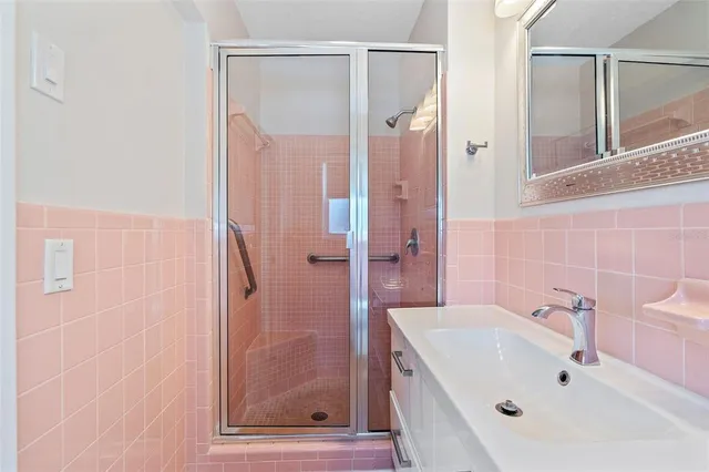 a bathroom with a tub a sink and mirror