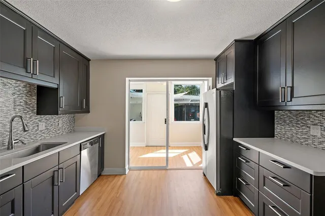 a kitchen with a sink stove and refrigerator