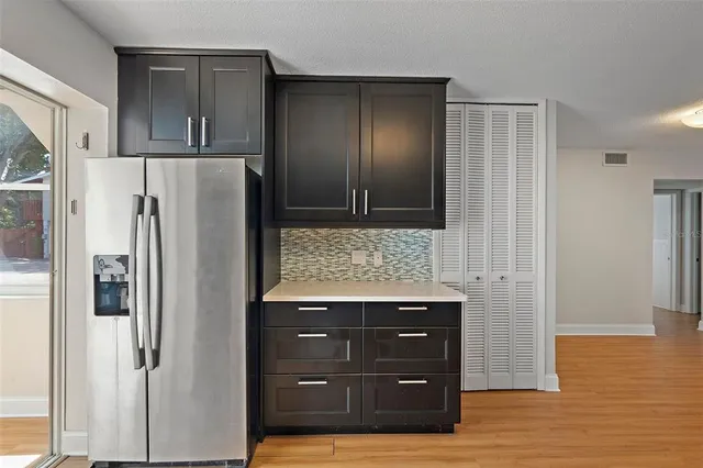 a kitchen with a refrigerator and cabinets