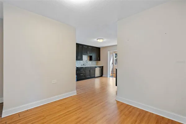 a view of a kitchen with a sink and a refrigerator