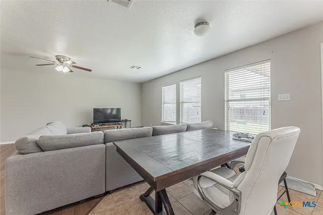 a living room with furniture a table and wooden floor