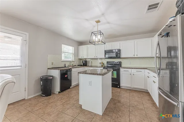 a kitchen with a sink stove and refrigerator