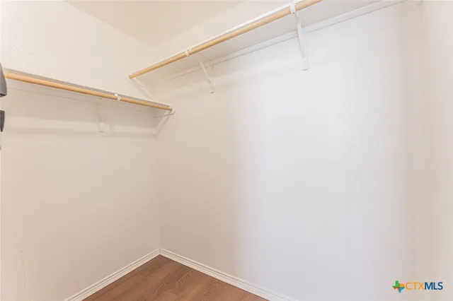 a bedroom with bed and a chandelier