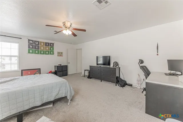 a bathroom with a double vanity sink toilet and mirror
