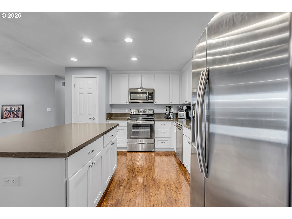3893 Southwest 4th Street Gresham, OR 97030 - Photo 15 of 48 a kitchen with kitchen island a counter top space cabinets and stainless steel appliances