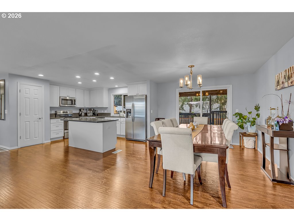 3893 Southwest 4th Street Gresham, OR 97030 - Photo 17 of 48 a living room with furniture wooden floor and a kitchen view
