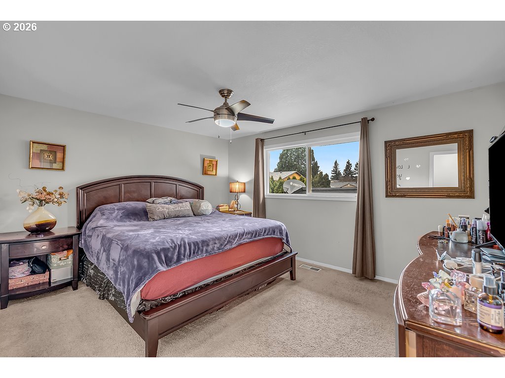 3893 Southwest 4th Street Gresham, OR 97030 - Photo 25 of 48 a bedroom with a bed and ceiling fan