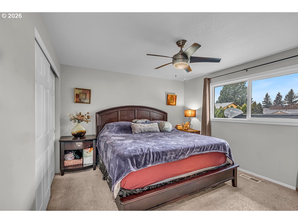 3893 Southwest 4th Street Gresham, OR 97030 - Photo 26 of 48 a bedroom with a bed and ceiling fan