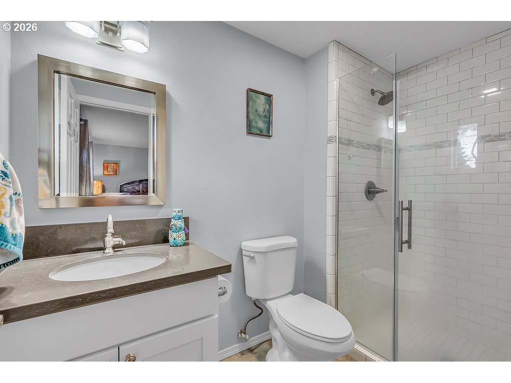 3893 Southwest 4th Street Gresham, OR 97030 - Photo 27 of 48 a bathroom with a sink toilet vanity and shower