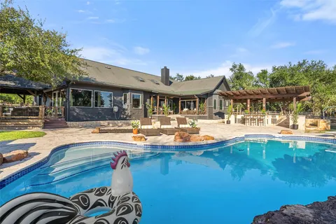 a view of a swimming pool with outdoor seating