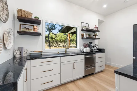 a kitchen with stainless steel appliances a stove and cabinets