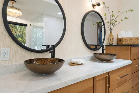 a view of a kitchen with a sink and a mirror