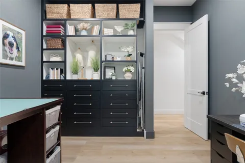 a room with a dresser and a window