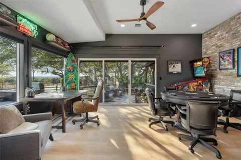 a view of a workspace with furniture and a window