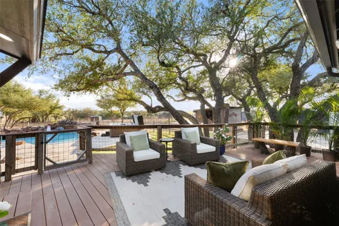 a roof deck with couches and wooden floor