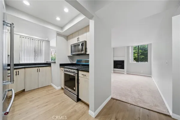 a view of a kitchen with a sink and chandelier