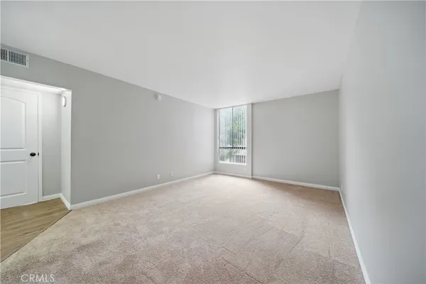 a view of an empty room with a window