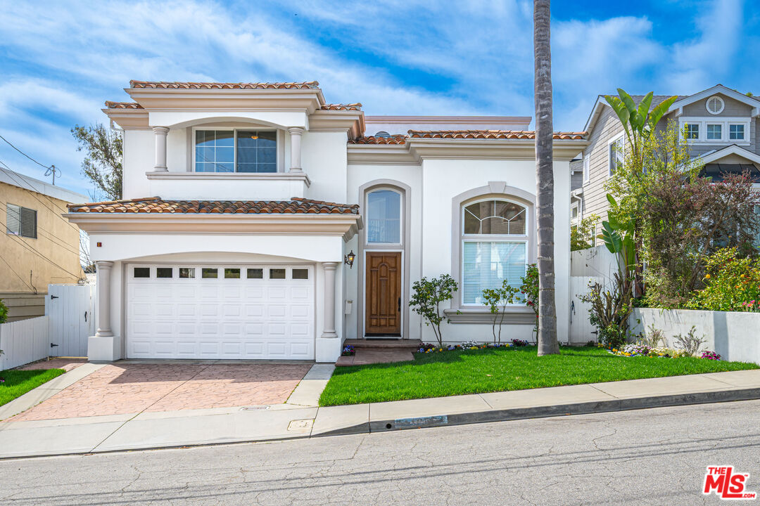 1756 Ruhland Avenue Manhattan Beach, CA 90266 - Photo 1 of 25 a front view of a house with a garden and a garage