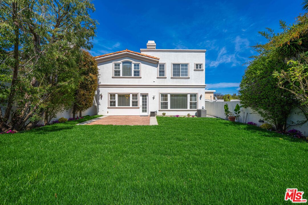 1756 Ruhland Avenue Manhattan Beach, CA 90266 - Photo 22 of 25 a large tree in front of a house next to a yard
