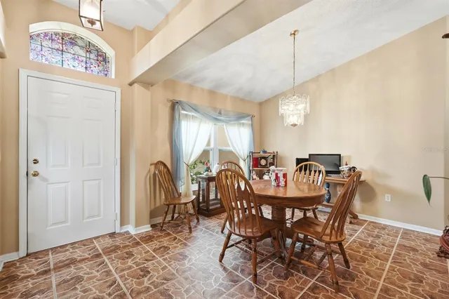 a view of a dining room with furniture window and outside view