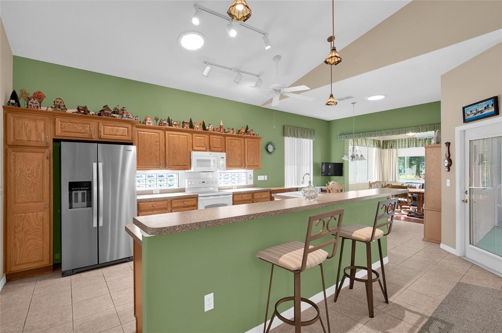 10777 Southwest 71st Circle Ocala, FL 34476 - Photo 14 of 47 a kitchen with stainless steel appliances kitchen island a large island in the center