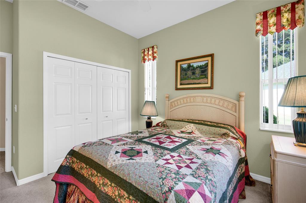 10777 Southwest 71st Circle Ocala, FL 34476 - Photo 32 of 47 a bedroom with a bed and a painting on the wall