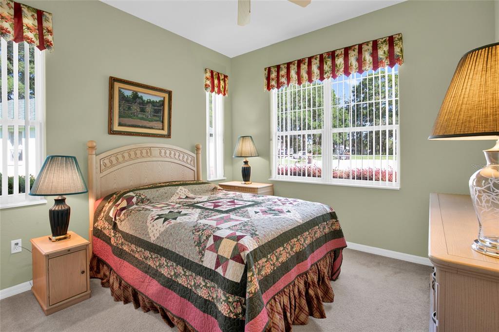 10777 Southwest 71st Circle Ocala, FL 34476 - Photo 33 of 47 a bedroom with a bed and a painting on the wall