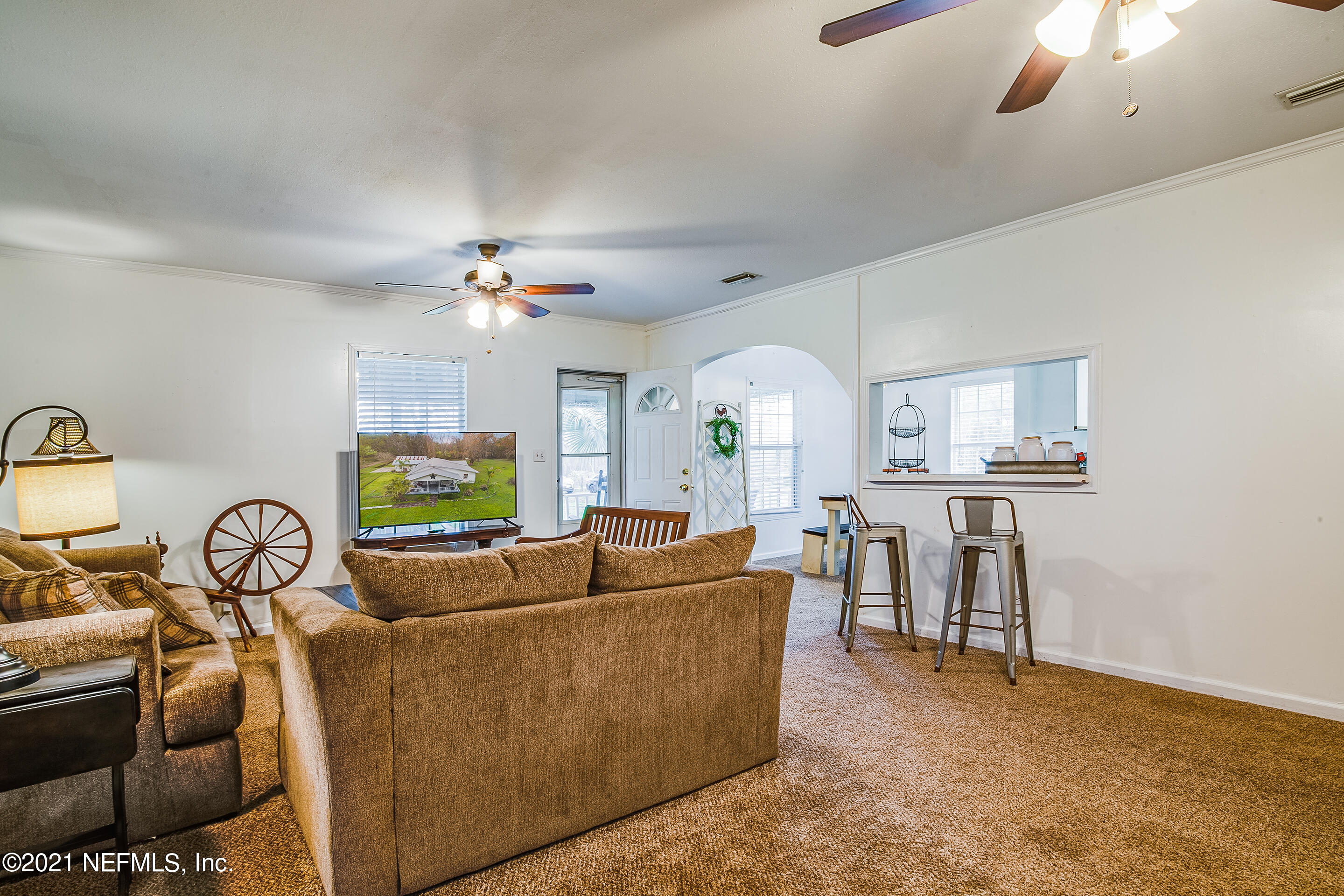 56117 Griffin Road Callahan, FL 32011 - Photo 14 of 30 a living room with furniture and a flat screen tv