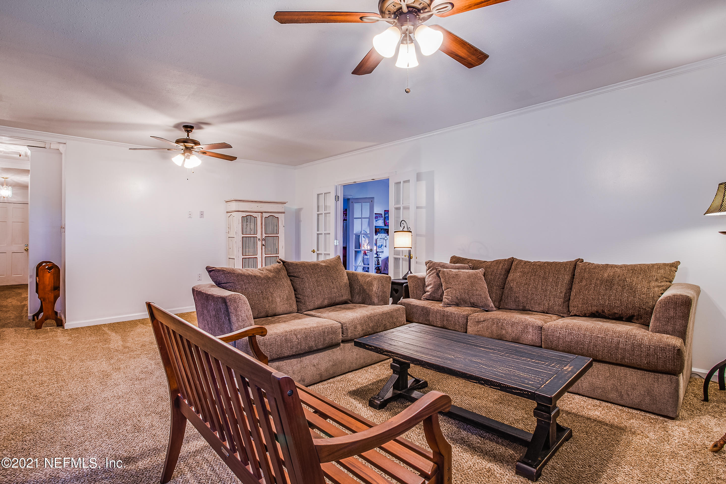 56117 Griffin Road Callahan, FL 32011 - Photo 15 of 30 a living room with furniture a ceiling fan and a rug