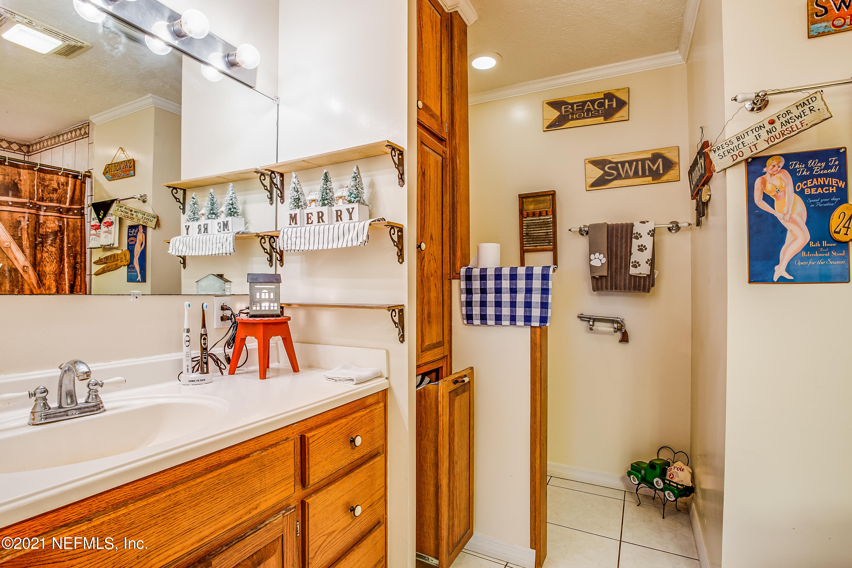 56117 Griffin Road Callahan, FL 32011 - Photo 22 of 30 a bathroom with a sink and a mirror