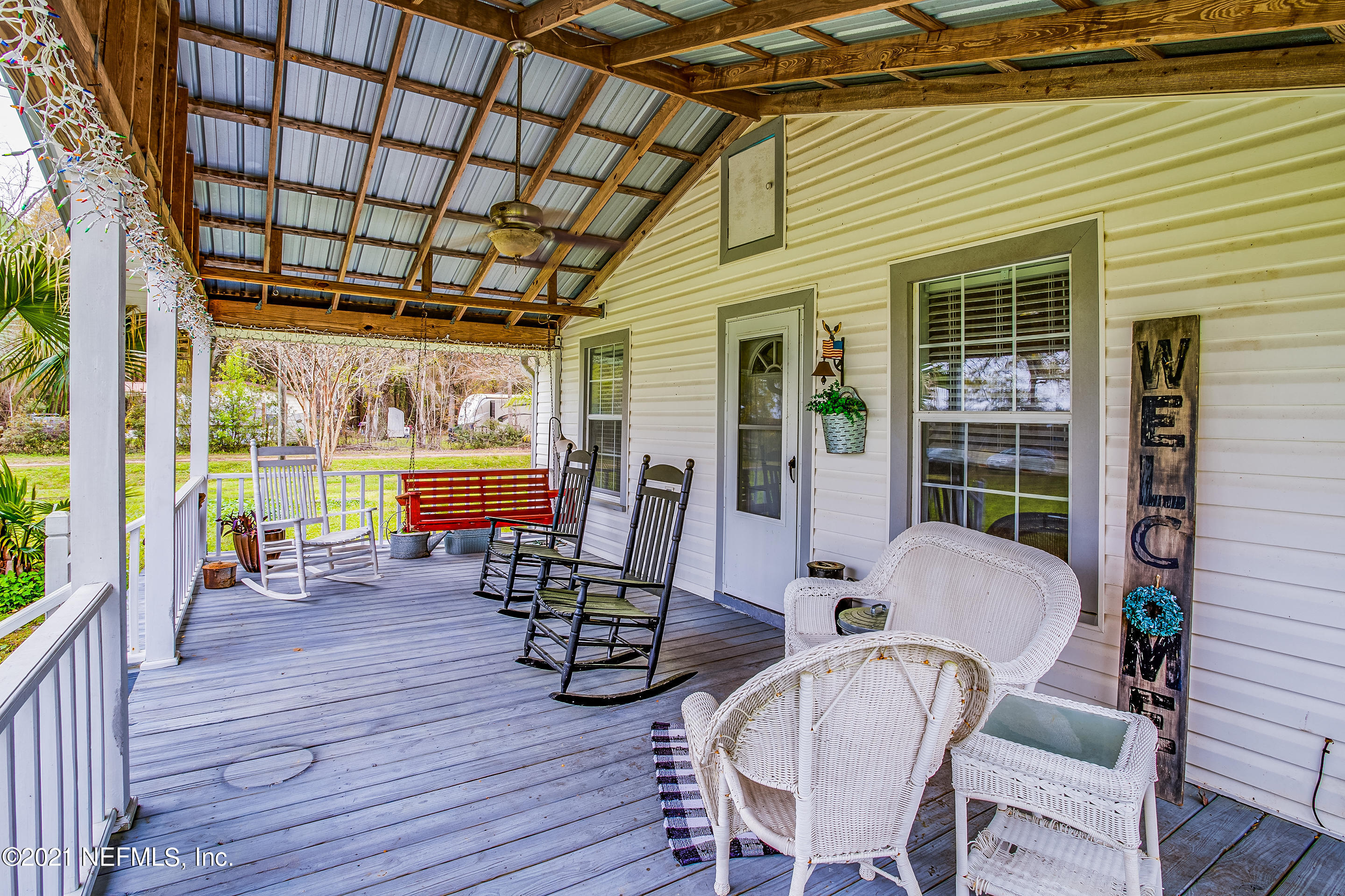 56117 Griffin Road Callahan, FL 32011 - Photo 8 of 30 a view of a patio with table and chairs and wooden floor