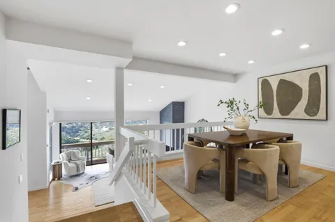 a view of a dining room with furniture and window