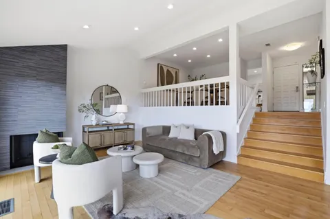 a living room with furniture and a potted plant