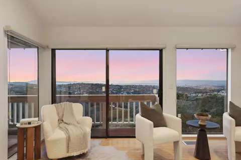 a living room with furniture and a floor to ceiling window