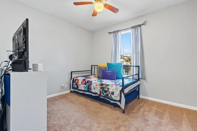 a bedroom with a bed and a chandelier