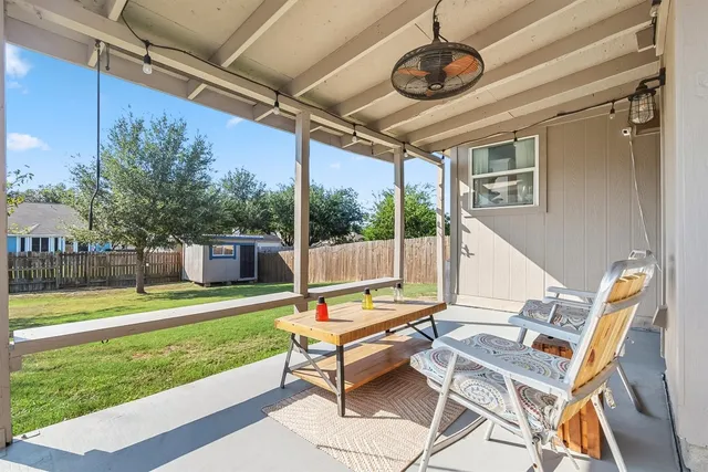 a swimming pool with outdoor seating and yard