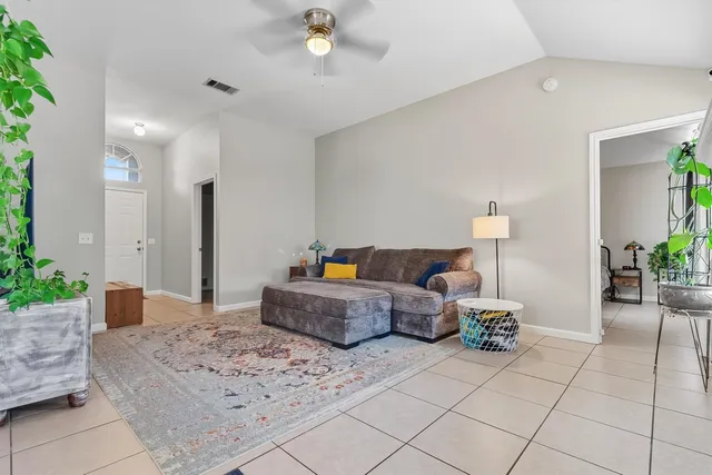 a living room with furniture and flowers