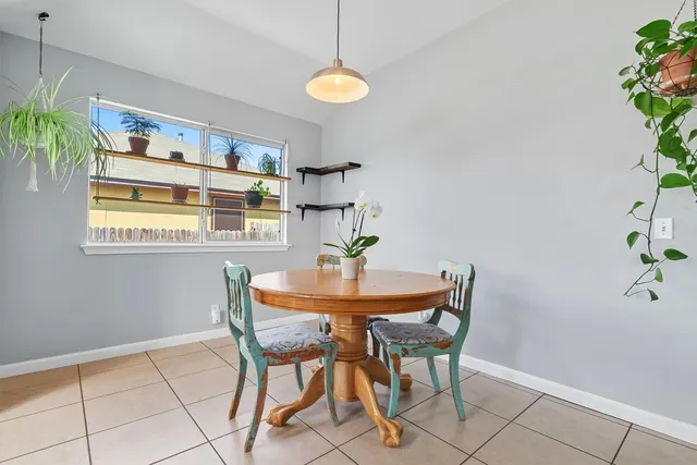 a dining room with furniture and window