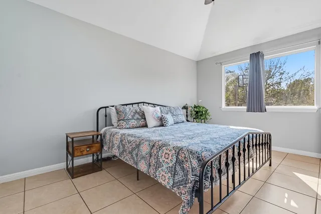 a bedroom with a bed and window